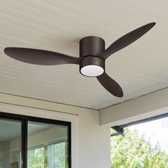 a ceiling fan that is on the outside of a house