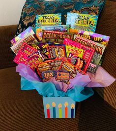 a box filled with candy and snacks on top of a couch