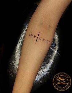 a person with a tattoo on their arm that reads invictus and has a lightning bolt