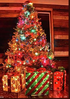 a decorated christmas tree with presents under it