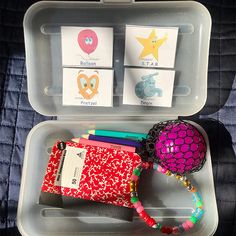 an open plastic container filled with lots of different items and writing materials on top of each other