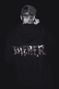 a man with his back to the camera wearing a black hoodie that reads berse