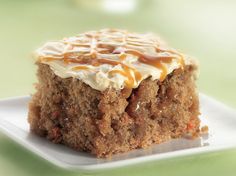 a close up of a piece of cake on a plate with frosting and toppings