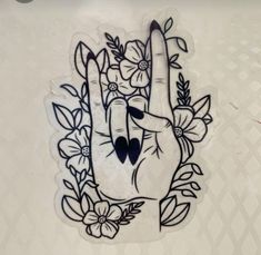 a hand with flowers and leaves on it is drawn in the shape of a peace sign