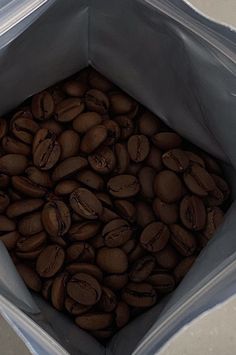 a bag full of coffee beans sitting on the ground