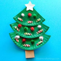 a paper plate christmas tree craft on a blue background