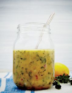 a glass jar filled with food sitting on top of a blue and white towel