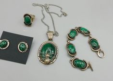 Native Navajo A.J. Singer Signed Sterling Silver 925 Malachite Stone Spider Necklace Jewelry Set Bracelet Ring and Earrings About this item Beautiful set of Malachite Jewelry with necklace, ring, bracelet, and earrings. The necklace measures 18 inches end to end and is marked sterling with the artist initials as shown . Made by Navajo artist A.J. Singer. The earrings are marked sterling, and the Bracelet measures 6 inches end to end. The pendant is 1 1/2 inches by 1 inch wide. The pendant and earrings match, the ring, and bracelet are a married set. The ring is marked sterling and I do not know the size.  Pictures do not do this set justice! The spider in Navajo tribes comes from Navajo mythology, Spider Woman is known as Na'ashjé'ii Asdzáá and is considered a powerful creator goddess who Navajo Mythology, Spider Necklace, Set Bracelet, Malachite Jewelry, Malachite Stone, Necklace Ring, Spider Woman, Unisex Gift, Bracelet Ring