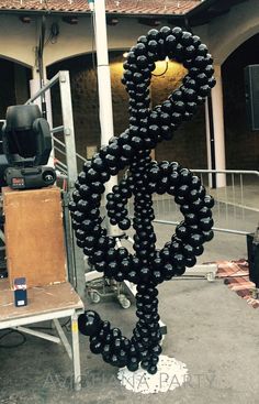 there is a sculpture made out of black balloons