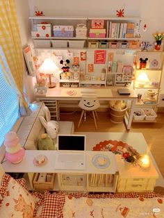 an aerial view of a room with a desk, laptop and bookshelf in it