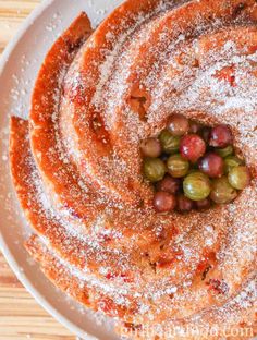 a white plate topped with cake covered in powdered sugar