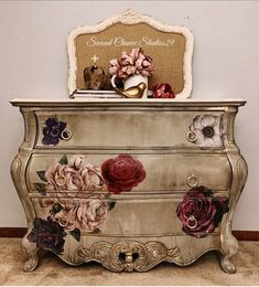 an ornate dresser with flowers painted on it