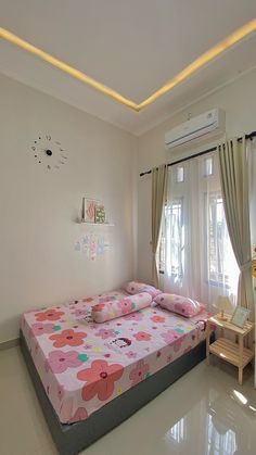 a bed room with a neatly made bed and curtains