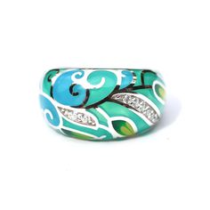 - Hand Enameled - Colorful leaves design in teal and green - Solid Sterling Silver 925  - Cubic Zirconia - 12mm wide tapering to 5mm Because this is such a wide ring, it will fit tighter than a thinner ring by around 1/2 a size. If you're not sure of your size I recommend having your finger sized at a jewelry store ( which they do for free ). Make sure to use the wide ring sizer. This ring was made by first carving it in wax and then casting it. I usually make two at a time from one casting. The ring itself was cast in sterling silver and then the enamelling was done. The enamel is done by hand so each ring is a little bit different.  I am inspired by nature so you will see quite a few flower pieces in my shop. Cloisonné (French pronunciation: [klwazɔne]) is an ancient technique for decora Green Enamel Ring For Anniversary, Unique Green Enamel Ring For Anniversary, Unique Green Enamel Anniversary Ring, Enamel Ring With Inlay, Green Enamel Anniversary Ring, Green Enamel Round Ring, Hand Painted Green Enamel Ring, Hand-painted Green Enamel Ring, Silver Enamel Collectible Ring