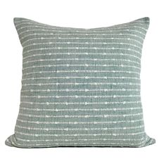 a light blue and white pillow on a white background