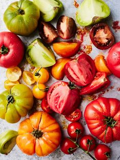 many different types of tomatoes on the table