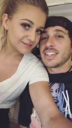 a young man and woman are posing for a selfie in front of the camera