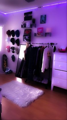 a bedroom with purple lighting and white fur rug