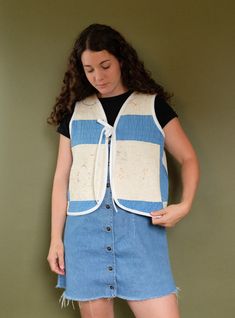 This quilt vest was made using a vintage quilt sourced from Minnesota, handcrafted the early 1900s. It features a stunning blue color palette and cross stitch & embroidered details than have worn over time. The pattern created for this vest has been designed to fit a variety of bodies. The sizing is boxy and accommodating to many body types! This quilt is light to medium weight, perfect for a transition in most seasons!Always remember that this coat is made from an antique quilt that has seen de Fall Blue Denim Patchwork Vest, Vintage Quilt Vest, Patchwork Denim Sleeveless Vest, Fitted Patchwork Denim Vest, Blue Sleeveless Patchwork Vest, Quilt Coat, Spring Runway, Blue Cross, Blue Embroidery