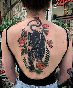 a woman with a black panther tattoo on her back