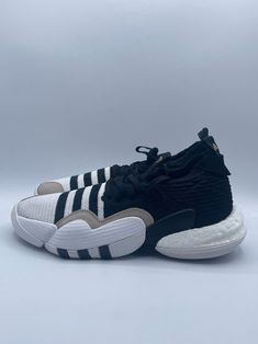 Elevate your basketball game with these Adidas Trae Young 2 sneakers. The low top shoes feature a knitted upper and rubber outsole for optimal performance on the court. They come in a stylish white and black striped pattern with lace-up closure, perfect for activewear occasions. Customized for ultimate comfort, these athletic shoes have a regular shoe width and are part of the Adidas New product line. Shoes are size 9 in US and 8.5 in UK. They are an ideal choice for any basketball enthusiast lo Sporty Striped Lace-up Sneakers, Sports Basketball Shoes With Elastic Laces, Sports Basketball Shoes With Elastic Laces And White Sole, Casual Adidas Basketball Shoes With White Sole, Low-top Basketball Shoes With Elastic Laces For Streetwear, Streetwear Basketball Shoes With Elastic Laces, Streetwear Low-top Basketball Shoes With Elastic Laces, Striped Low-top Sneakers For Streetwear, Adidas Low-top Basketball Sneakers