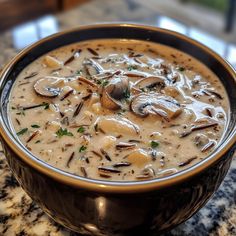 a bowl filled with soup sitting on top of a table