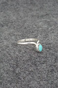 This simple yet elegant turquoise and sterling silver ring was made by Navajo silversmith Hiram Largo. The inside of the band is stamped sterling. (Please note: the stone color may vary slightly from the photos.)Size: 9.5Stone Length: 1/4"Stone Width: 3/16"Free shipping on all orders! We ship with USPS and always include tracking. All orders ship within a day of payment.Returns are accepted up to 30 days after you receive your order. Just send us a message. Our shop offers cash back or store credit. The item must be returned in new condition. Turquoise Sterling Silver, Stone Color, Sterling Silver Rings, Silver Rings, Turquoise, Stamp, Band, Sterling Silver, Stone