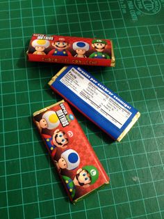 two candy bars sitting on top of a green cutting board