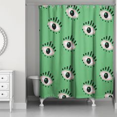 a green shower curtain with an eye pattern