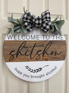 a wooden sign that says, welcome to the skitshow hope you brought alcohol