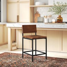 a wooden chair sitting on top of a rug in a kitchen next to a counter