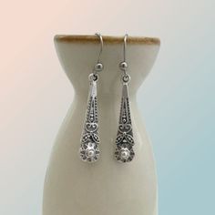 Introducing our Antiqued Silver Boho Flower Earrings, the perfect everyday accessory that effortlessly blends casual charm with a touch of vintage elegance. These beautifully detailed earrings boast an antiqued silver finish, lending them a soft and rustic appearance. Their long and slender shape, measuring 27mm x 8mm, makes them an ideal choice for both casual and dress-up occasions. The intricate flower design adds a touch of delicacy to these earrings, elevating their overall appeal. For utmo Vintage Hypoallergenic Drop Earrings, Hypoallergenic Vintage Drop Earrings, Classic Silver Teardrop Earrings Gift, Vintage Nickel-free Earrings For Everyday, Vintage Nickel-free Teardrop Earrings, Elegant Antique Silver Nickel-free Earrings, Elegant Nickel Free Antique Silver Earrings, Elegant Nickel-free Antique Silver Earrings, Vintage Silver Teardrop Pierced Earrings