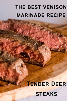 two steaks sitting on top of a wooden cutting board with the words tender deer steaks