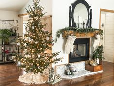 a living room with a christmas tree and fireplace