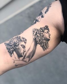 a woman's arm with some tattoos on it