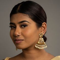 Add elegance with our White Mahila Kundan Earrings. This piece feautures high-quality Tyaani Kundan on silver foiling with an intricate Meenakari design a White crystals. Specifications Materials used: Tyaani Kundan, Silver Foiling, Gold plating, Meenakari At Romikas, we pride ourselves on the craftsmanship and high quality of our jewelry, designed to enhance your natural beauty. Please contact us with any questions. Fusion Style Tilla Earrings For Eid, Bollywood Style Silver Bridal Earrings With Cutdana, White Temple Jewelry Chandelier Earrings, Fusion Style Meenakari Pearl Earrings, Silver Chandbali Bridal Earrings With Cutdana, Elegant Meenakari Chandelier Earrings For Eid, Traditional White Jhumkas For Pierced Ears, Silver Chandelier Earrings With Cutdana For Festivals, Fusion Style Meenakari Pearl Earrings For Celebrations