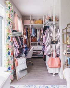 an organized closet with clothes and handbags on shelves, hanging from the ceiling in front of a window