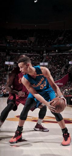 two men are playing basketball on the court