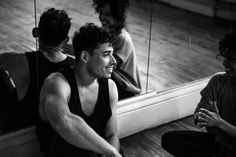 a man sitting on the floor in front of a mirror