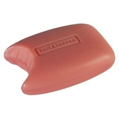 a pink soap bar sitting on top of a white surface with the word toiletpaper written in red