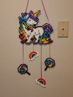 a wall hanging made out of legos with a unicorn on it's back