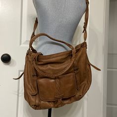 Excellent Used Condition Isabella Fiore Leather Handbag. Can Be Used As A Satchel Or Crossbody. Comes With Shoulder Strap And Dust Bag. Brown Crossbody Saddle Bag For Errands, Camel Satchel Hobo Bag With Adjustable Strap, Camel Crossbody Shoulder Bag With Leather Handles, Dark Tan Satchel With Adjustable Strap, Camel Leather Crossbody Bag, Dark Tan Crossbody Shoulder Bag For Everyday Use, Dark Tan Crossbody Bag With Detachable Strap, Brown Saddle Bag With Detachable Handle For Everyday, Camel Satchel Bag For Errands