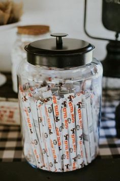 a jar filled with lots of candy sitting on top of a table