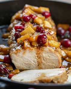 pork with apples and cranberry sauce in a skillet