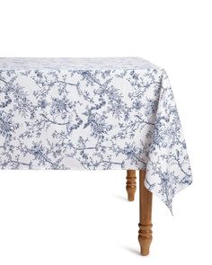 a blue and white floral tablecloth on a wooden leg with an old - fashioned design