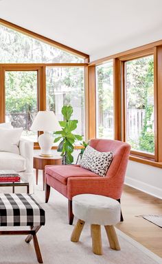 a living room filled with furniture and lots of windows