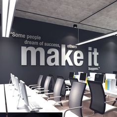 an office with black walls and white desks in front of the wall that says make it happen