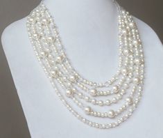 Cream pearl necklace multistrand, 3 strand,  with clear aurora borealis crystals, wedding, casual  This piece has a simple,modern twist on the classically beautiful, vintage pearl necklace from your grandmother's jewelry box. 5 long strands of shiny cream pearls are accented with glistening clear AB crystals and finished with beautiful Tibetan bead cones and a sturdy toggle clasp for easy on and off.  Dress it up, or wear it casual. This jewelry can be worn with everything from a wedding dress t Multi-strand Pearl Beaded Necklace For Wedding, Wedding Multi-strand Pearl Beaded Necklace, White Pearl Crystal Necklaces For Wedding, Wedding White Pearl Crystal Necklaces, Vintage Pearl Necklace, Seed Bead Bracelet Patterns, Crystals Wedding, Grandmother Jewelry, Wedding Casual