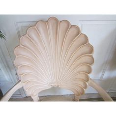 a shell shaped chair sitting in front of a door