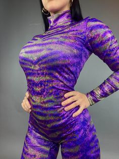 About this item Avatar Purple Catsuit - Perfect for Aerial and Contortion Shows!Elevate your performance with our Avatar Purple Catsuit, designed for aerial and contortion showsCrafted from high-quality 4-way stretch fabric with a hologram metallic pattern printAvailable in Green (and customizable in Red, Blue, and more - just send me a message!)Features a scoop neck, long sleeves, long legs, and a convenient back zipper for easy wearCustomization Options:Want to customize the design to your lik Fitted Party Unitard With Thumbholes, High Stretch Unitard With Thumbholes For Party, Rave Style Fitted Party Leotard, Fitted Purple Unitard, Fitted Dance Bodysuit With Thumbholes, Fitted Multicolor Unitard For Party, Fitted Dance Unitard With Thumbholes, Fitted Bodysuit With Thumbholes For Dance, Fitted Rave Bodysuit For Party